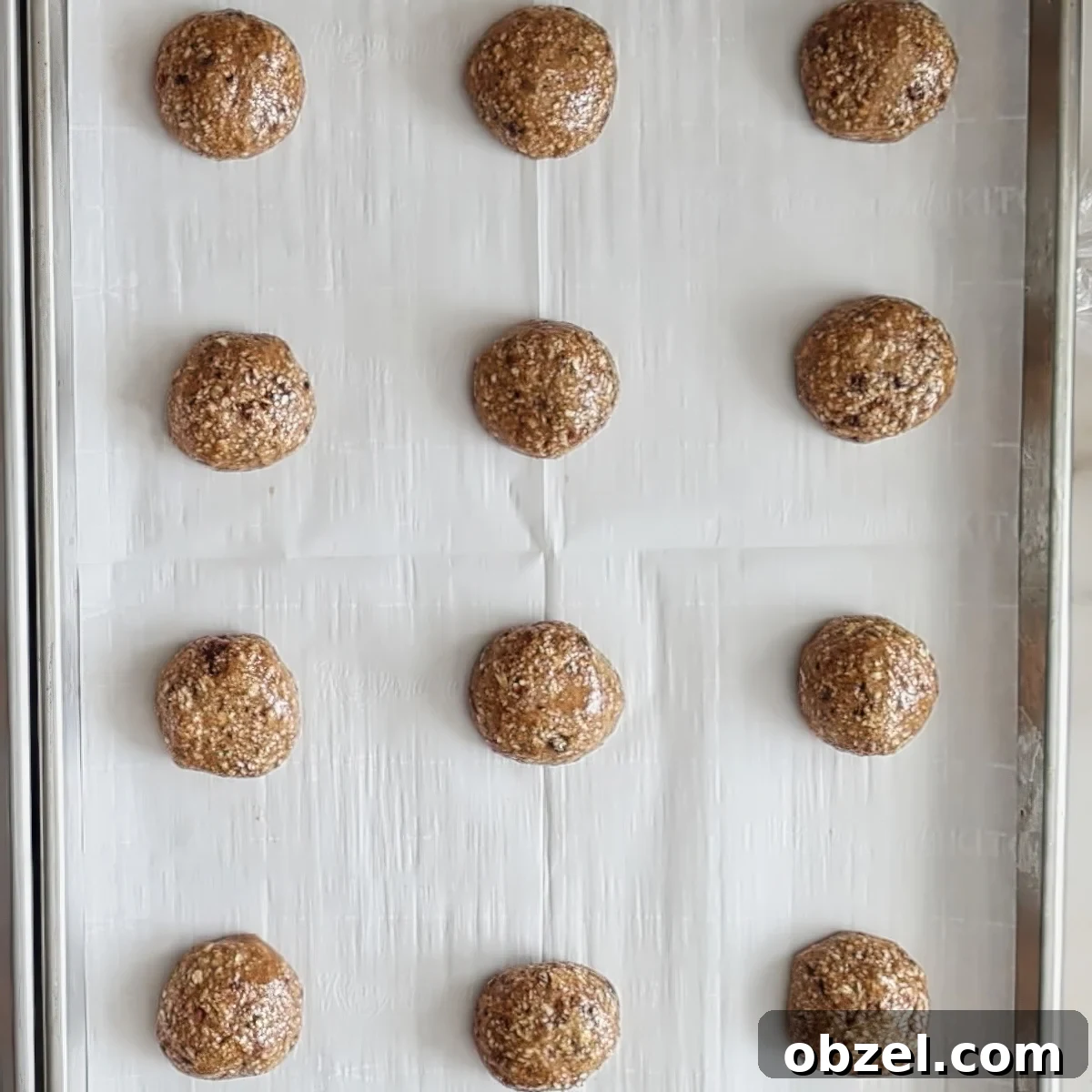 round scoops of cookie dough on parchment-lined baking sheet.