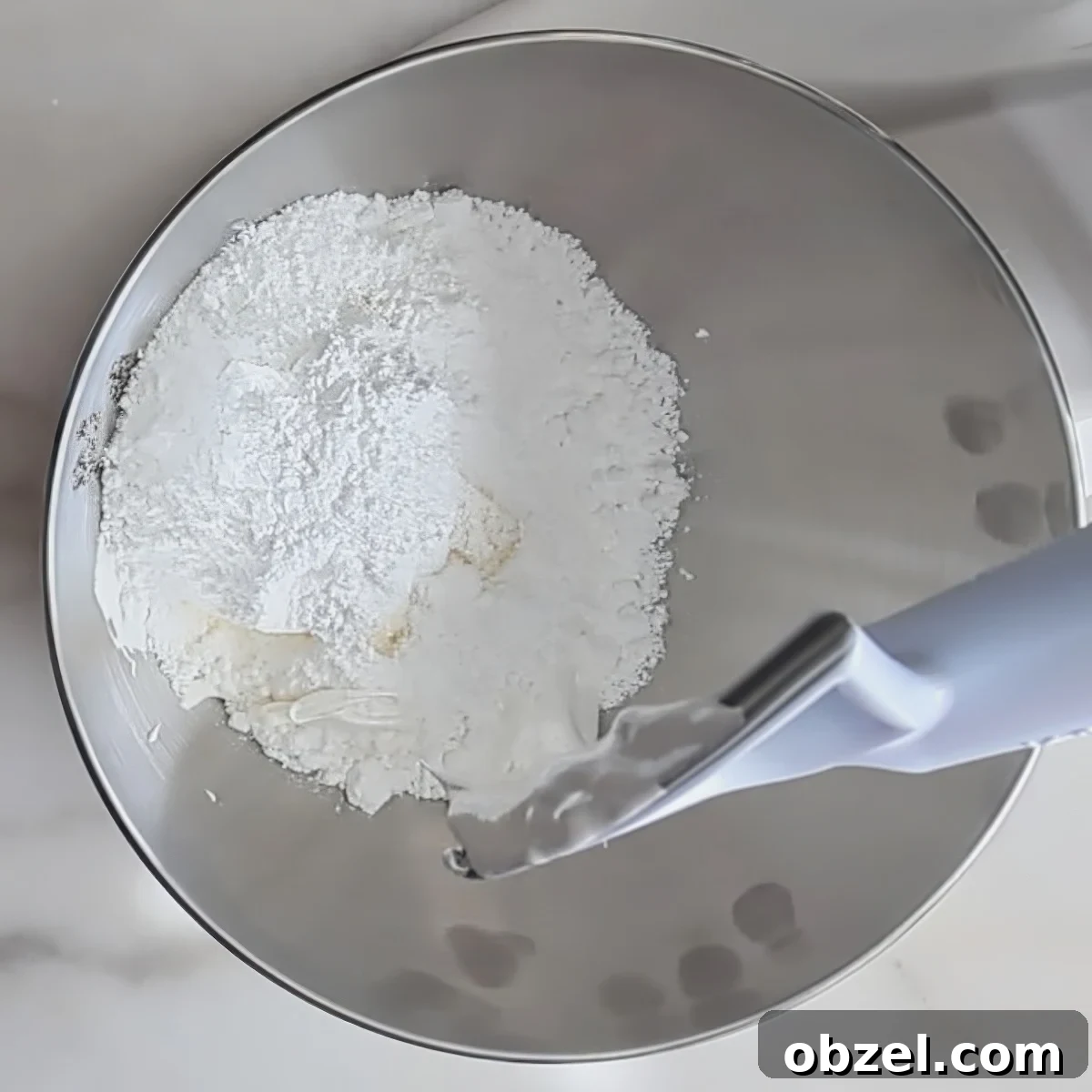 white powder in stainless steel mixing bowl.
