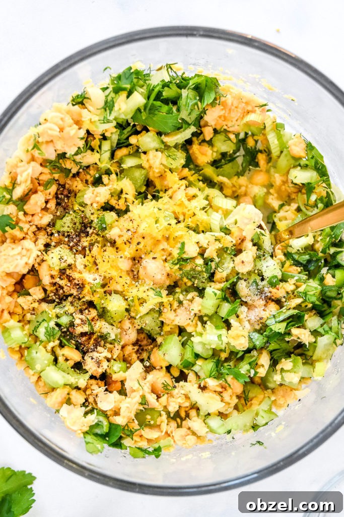 Lemony Herbed Mashed Chickpea Salad Recipe 9 herby lemon mashed chickpea salad with lemon zest, salt and pepper on top.