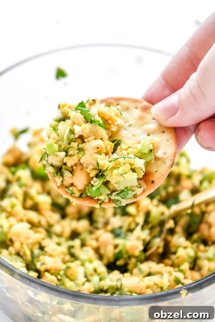 Lemony Herbed Mashed Chickpea Salad Recipe 14 herby lemon mashed chickpea salad on a cracker.