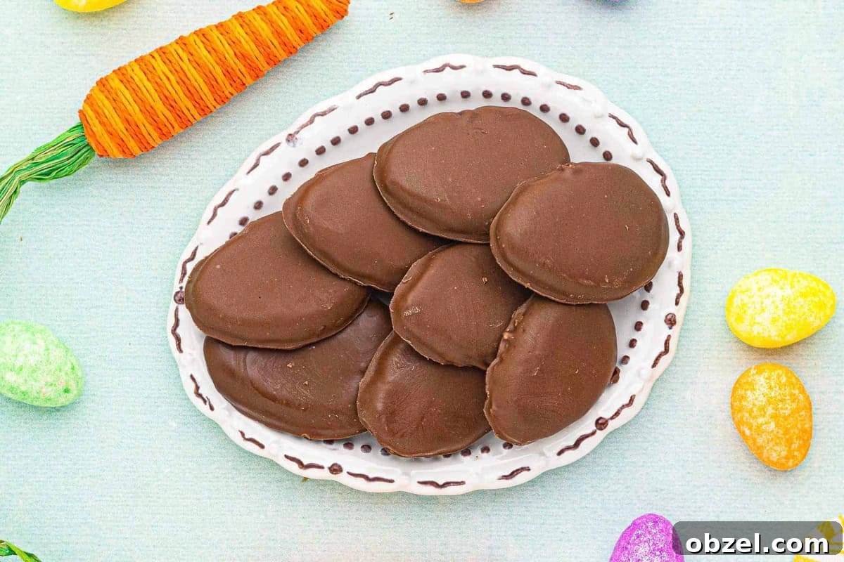 Reese's Peanut Butter Eggs: Where to Buy and Nutrition 3 reese's peanut butter eggs stacked on an egg-shaped ceramic platter.