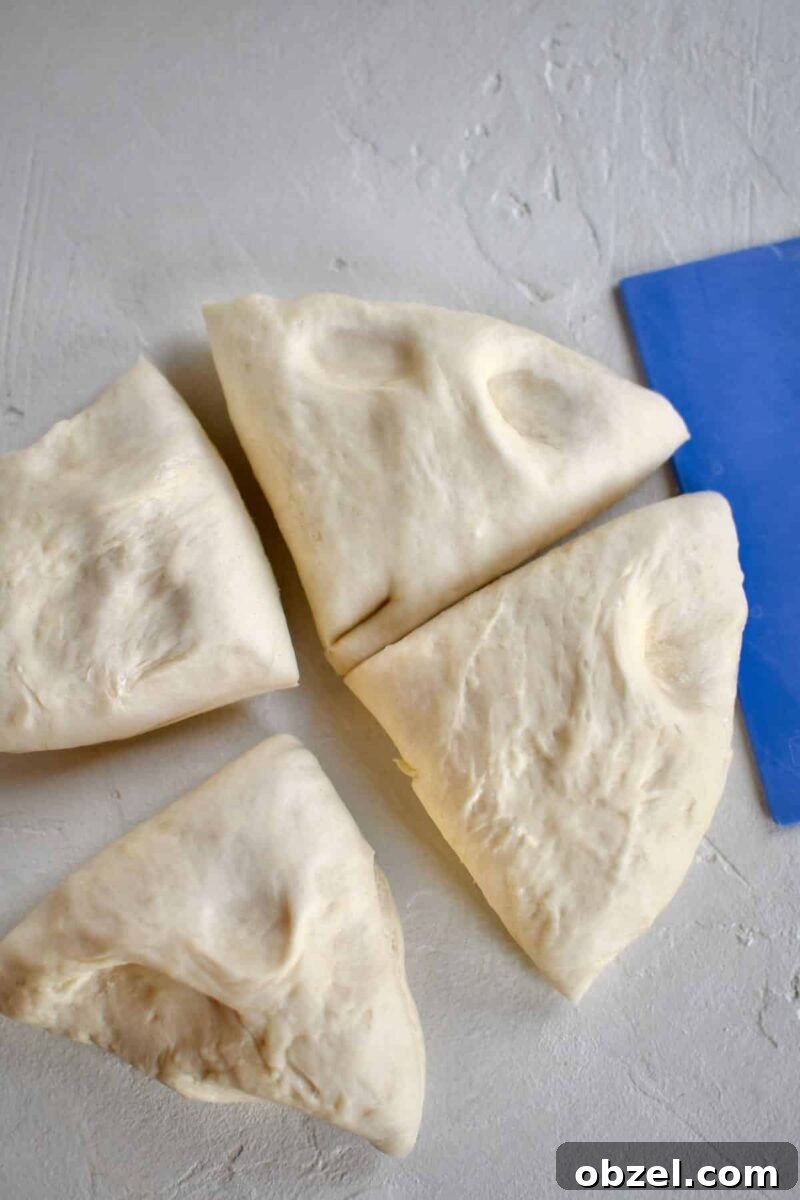cutting the proved dough into 4 pieces before rolling out and cutting.