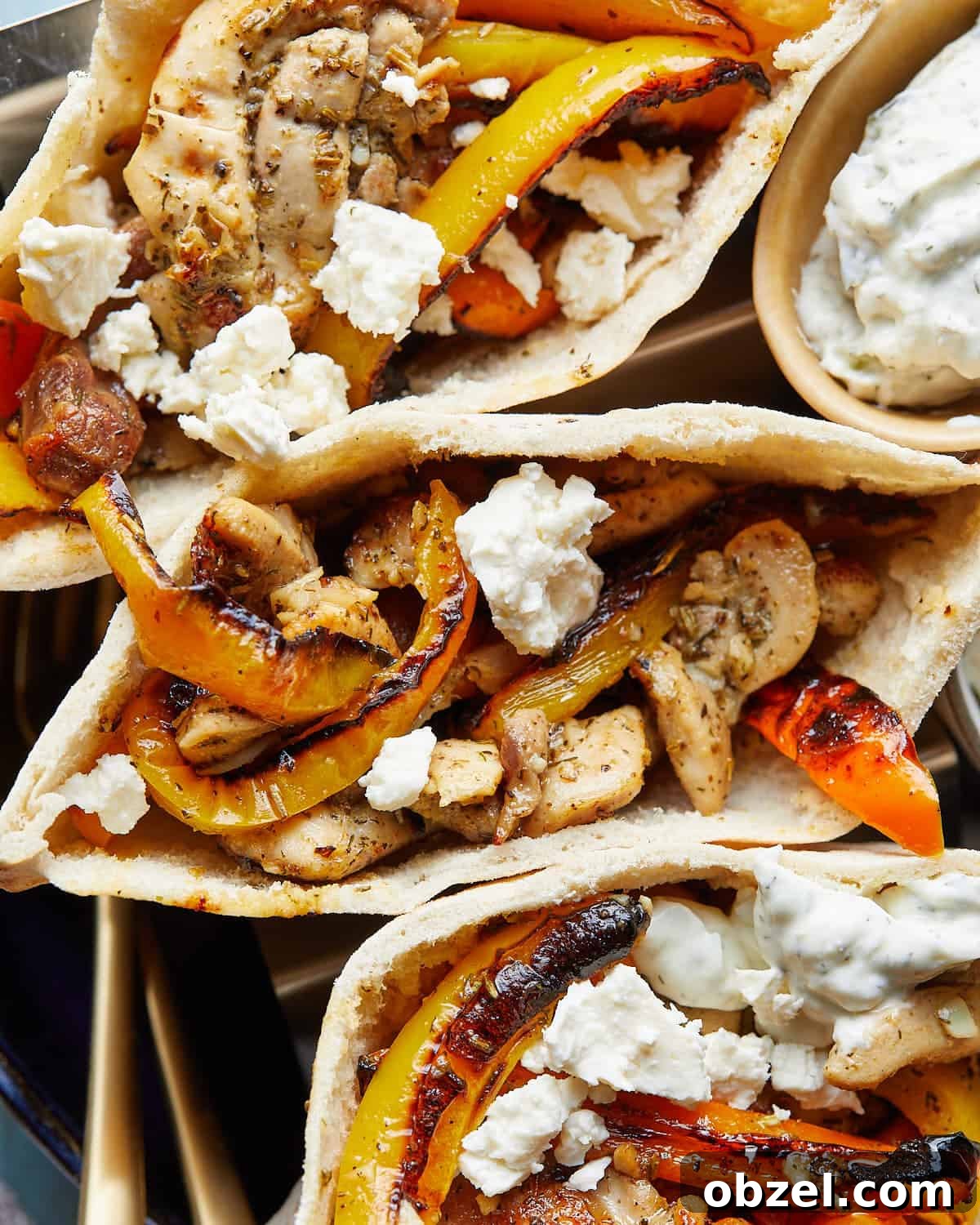 Up close image of chicken pita pockets with garnish.
