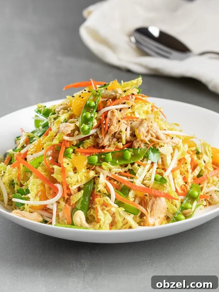 Chinese Chicken Salad with Sesame Ginger Dressing 12 healthy Chinese chicken salad in a white bowl and grey tile