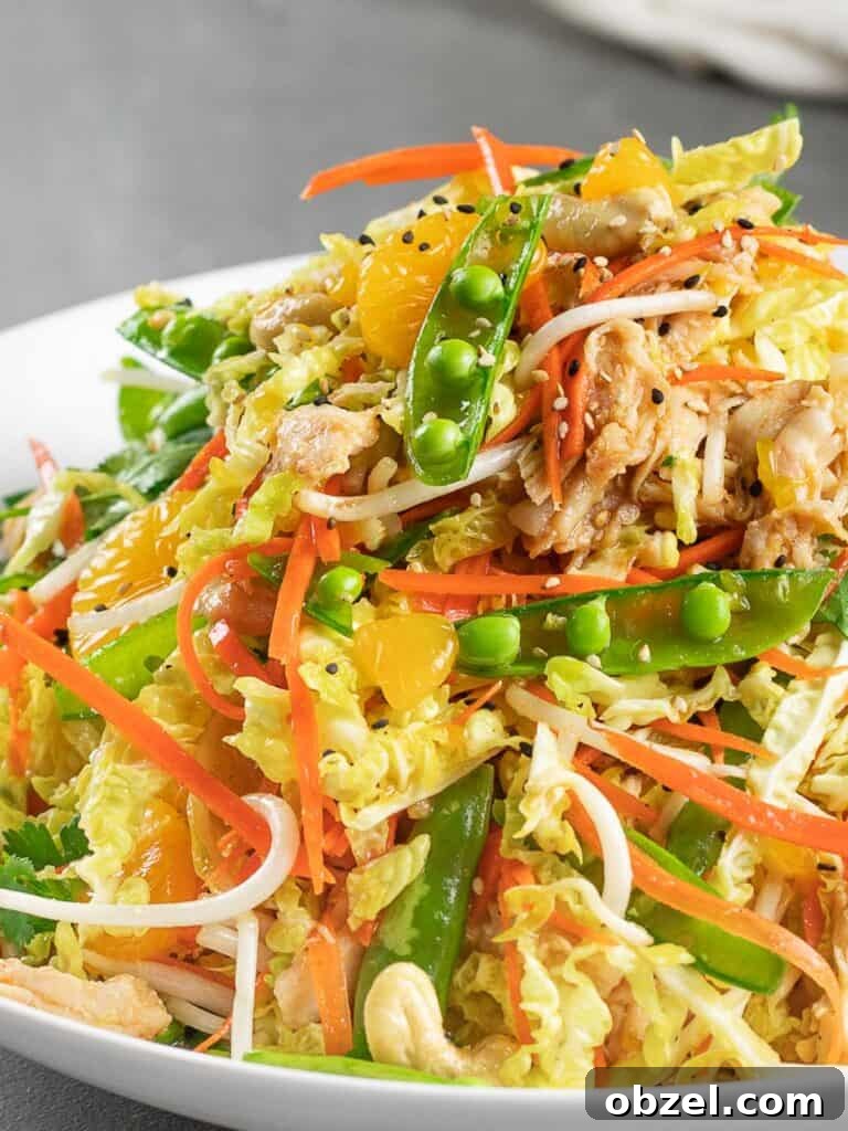 Chinese Chicken Salad with Sesame Ginger Dressing 3 healthy Chinese chicken salad in a white bowl and grey tile