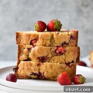 Strawberry buttermilk bread, sliced and stacked on a white plate.