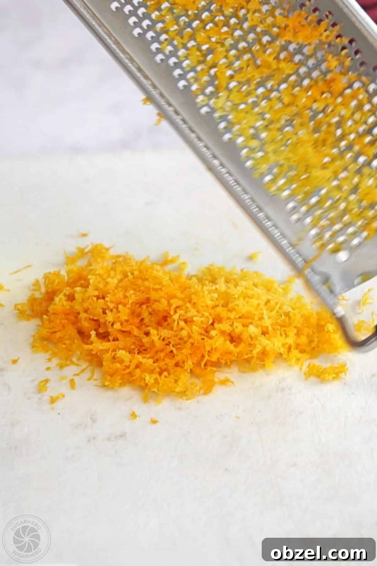 Cranberry Orange Sauce Recipe 7 Fresh orange zest in a small pile below a microplane.