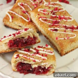 3 Cranberry White Chocolate Sweetie Pies on a plate with the front pie cut in half to show inside.