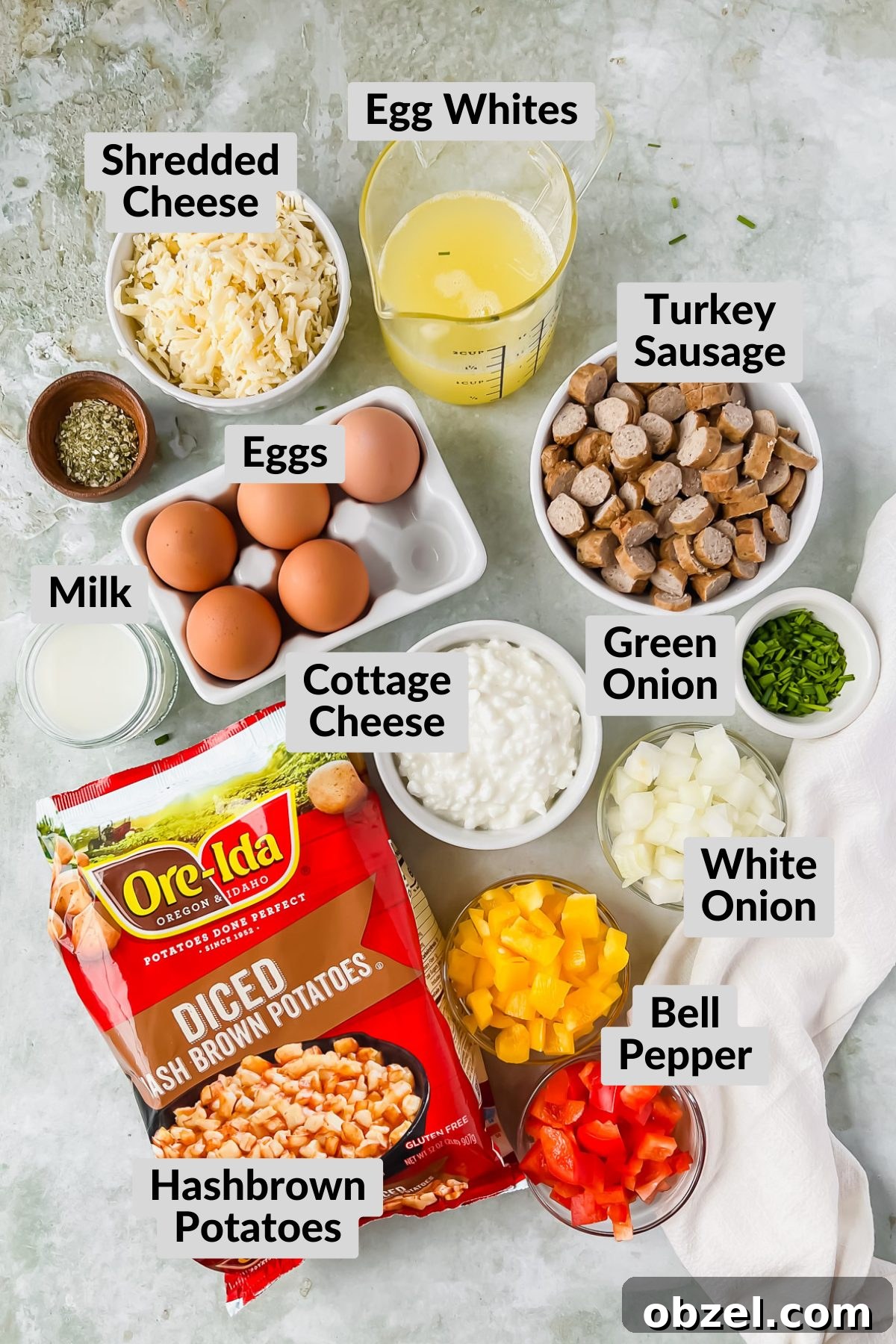 Cheesy Loaded Hashbrown Casserole with Bacon 3 ingredients for loaded hashbrown casserole in individual bowls on gray background.