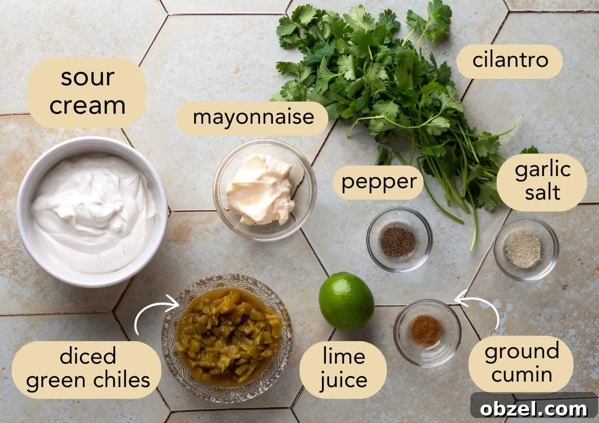 Creamy Green Chile Cilantro Dip 3 overhead of ingredients needed to make green chile dip in bowls on an ivory tile surface
