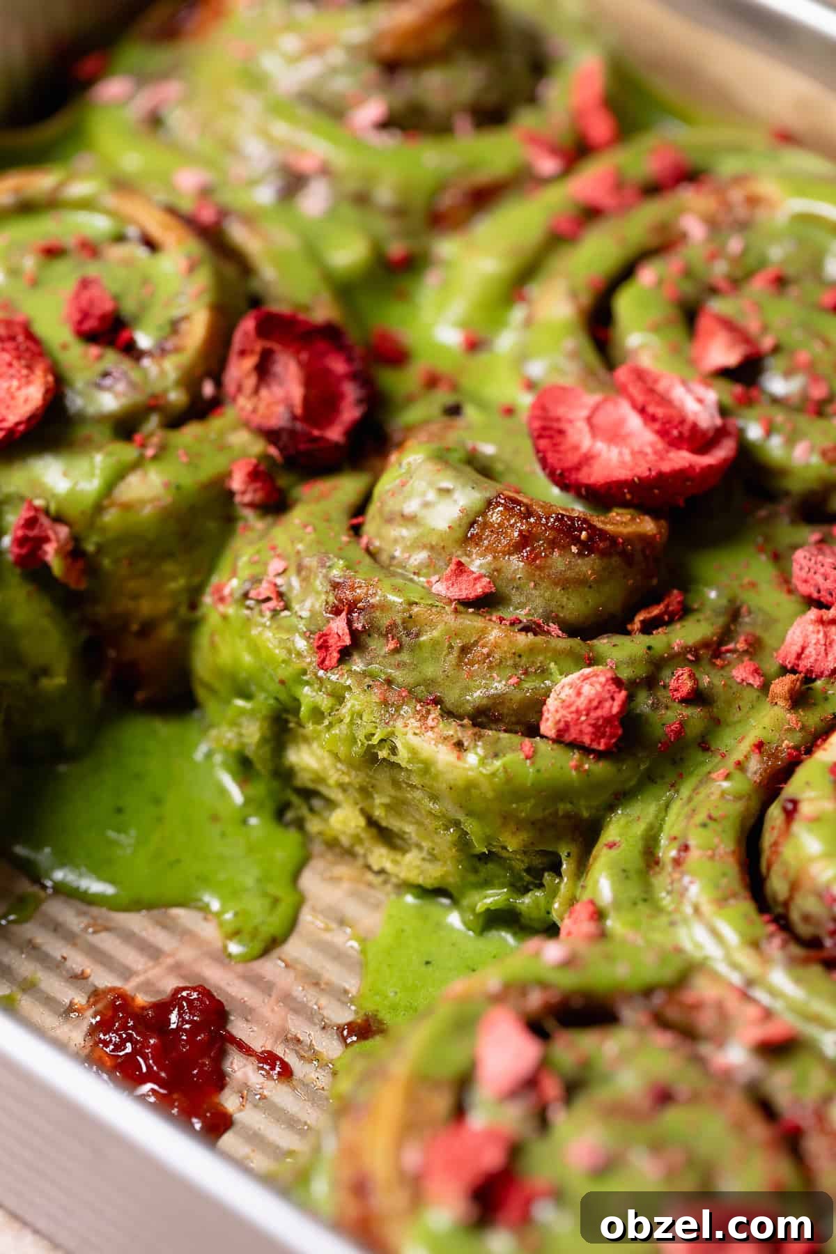 Strawberry Matcha Cinnamon Rolls Recipe 2 Matcha cinnamon rolls in a baking pan.