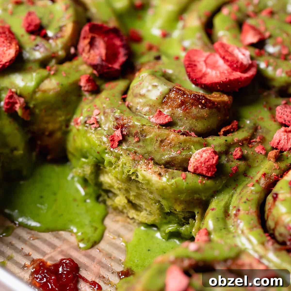Strawberry Matcha Cinnamon Rolls Recipe 14 Strawberry matcha cinnamon rolls in a baking pan.