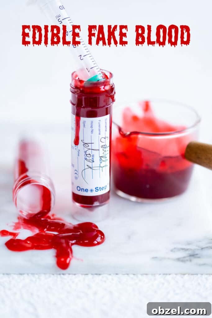 edible fake blood in a test tube with some spilled in foreground