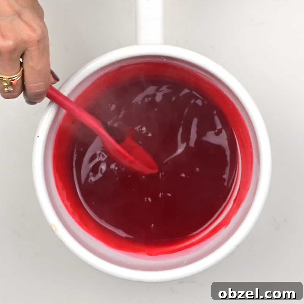 stirring edible fake blood in a saucepan