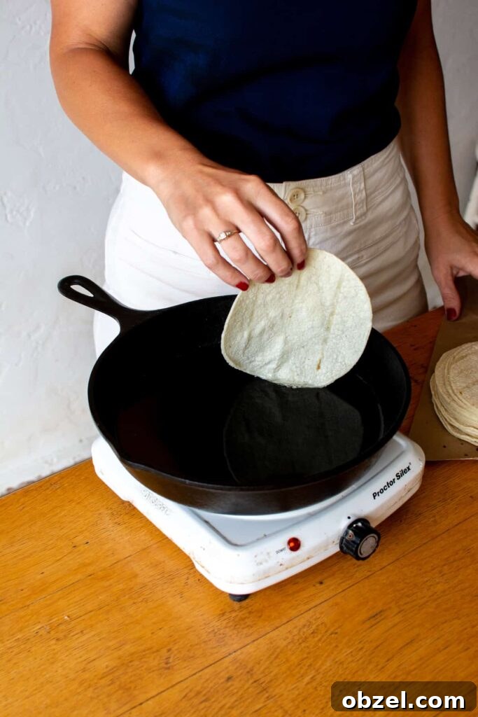 How to Make Crispy Fried Tostadas at Home 5 Frying a corn tortilla for homemade tostadas