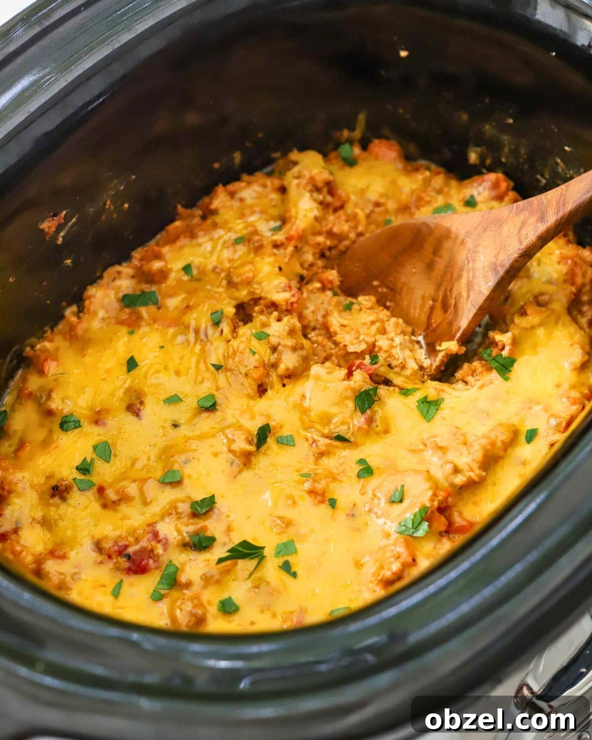 Slow Cooker Ground Pork Casserole Recipe 2 Slow cooker filled with cooked ground pork, rice and cheese.