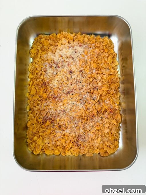 Crushed cornflakes with seasoning in a dish.