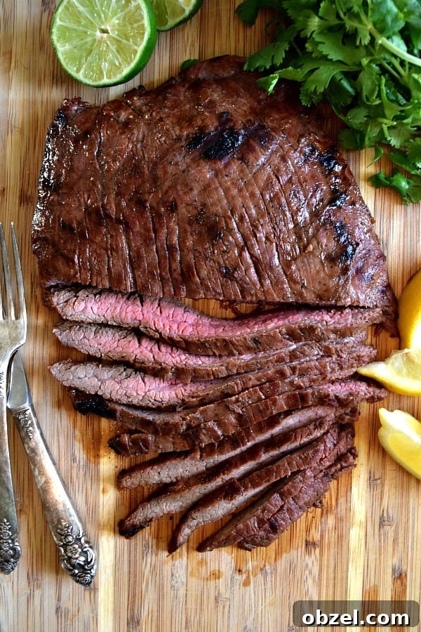 Top New Recipes on The Schmidty Wife in 2018 2 Overhead shot of grilled flank steak, half cut into strips showing off the pink meat inside