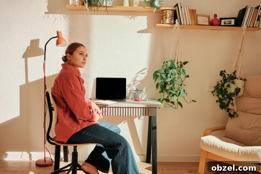 How Remote Work Is Reshaping Homebuyer Preferences 2 Woman sitting at a cozy home office desk with plants and sunlight, representing the importance of natural light and comfort for remote work buyers.