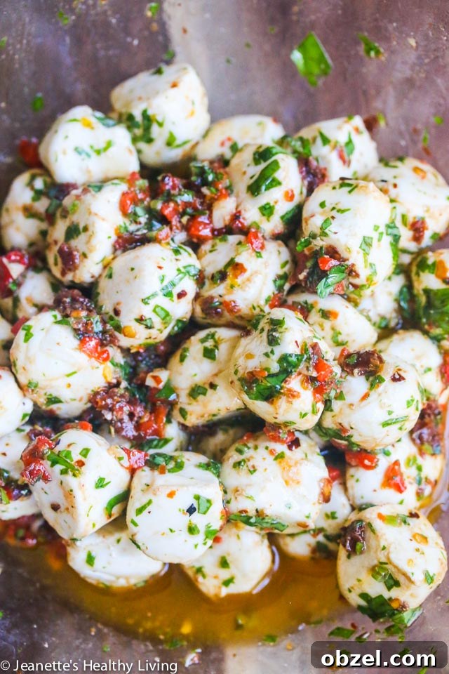 Marinated Mozzarella Balls - always a party favorite - super easy and delicious with sun dried tomatoes, roasted red peppers, basil and parsley