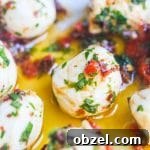 Marinated Mozzarella Balls - skewer with cherry tomatoes for a party appetizer - always a party favorite - super easy and delicious