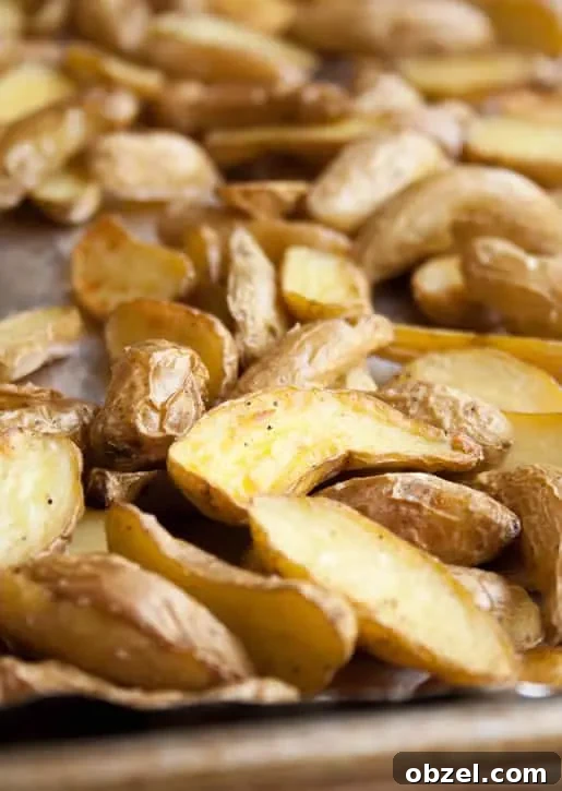 A closeup image of roasted halved potatoes to make Roasted Potato Salad with Avocado Lime Dressing from themerchantbaker.com