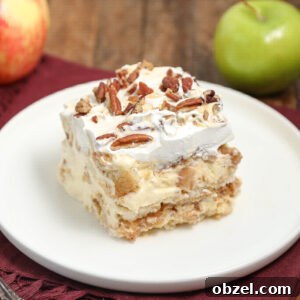 Caramel Apple Tiramisu Recipe: Autumn Dessert Twist 8 A slice of creamy caramel apple tiramisu topped with whipped cream and chopped pecans sits on a white plate, with a red napkin and apples in the background.