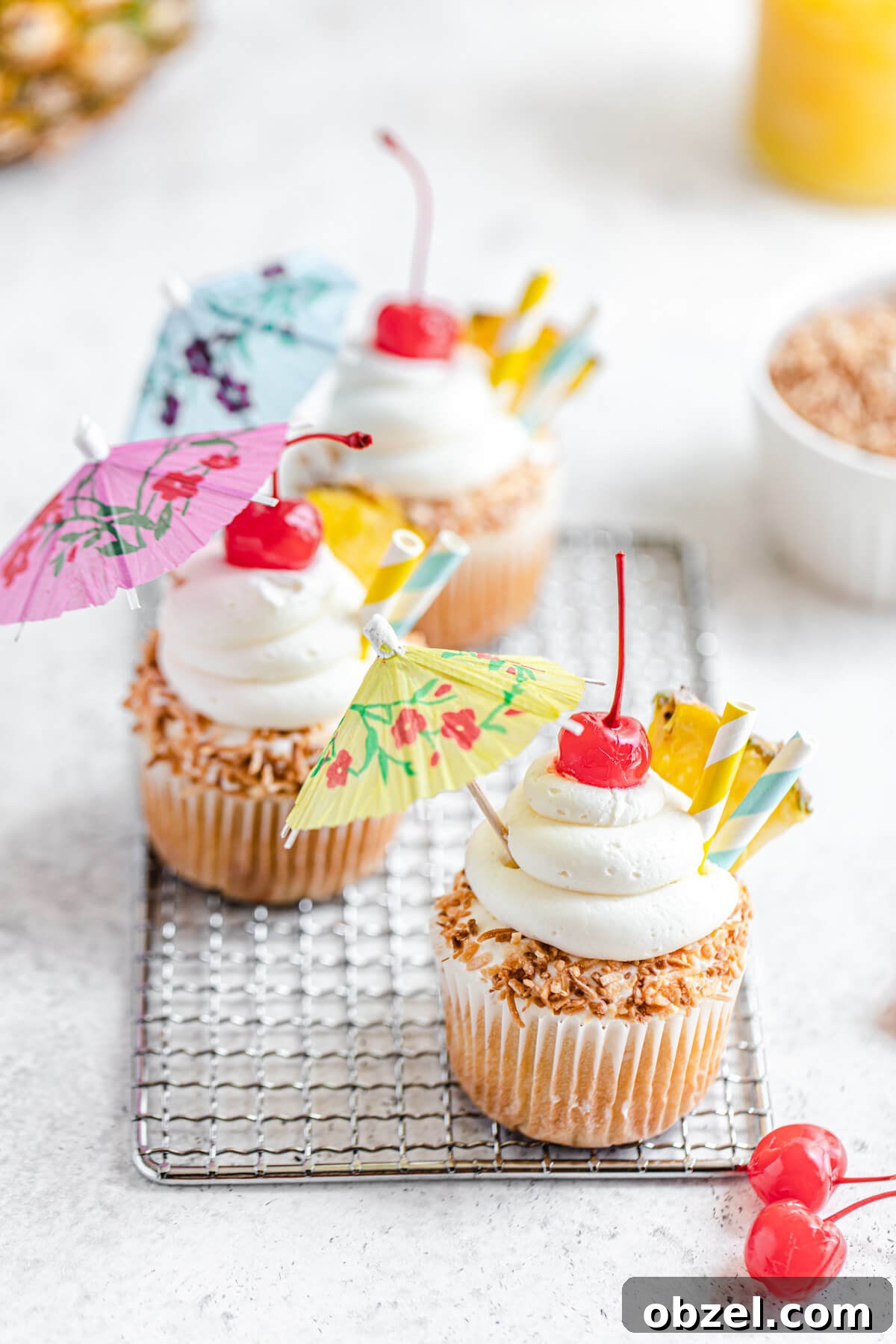 Pina Colada Cupcakes with Rum Infused Coconut Frosting 3 three cupcakes on a safety grater