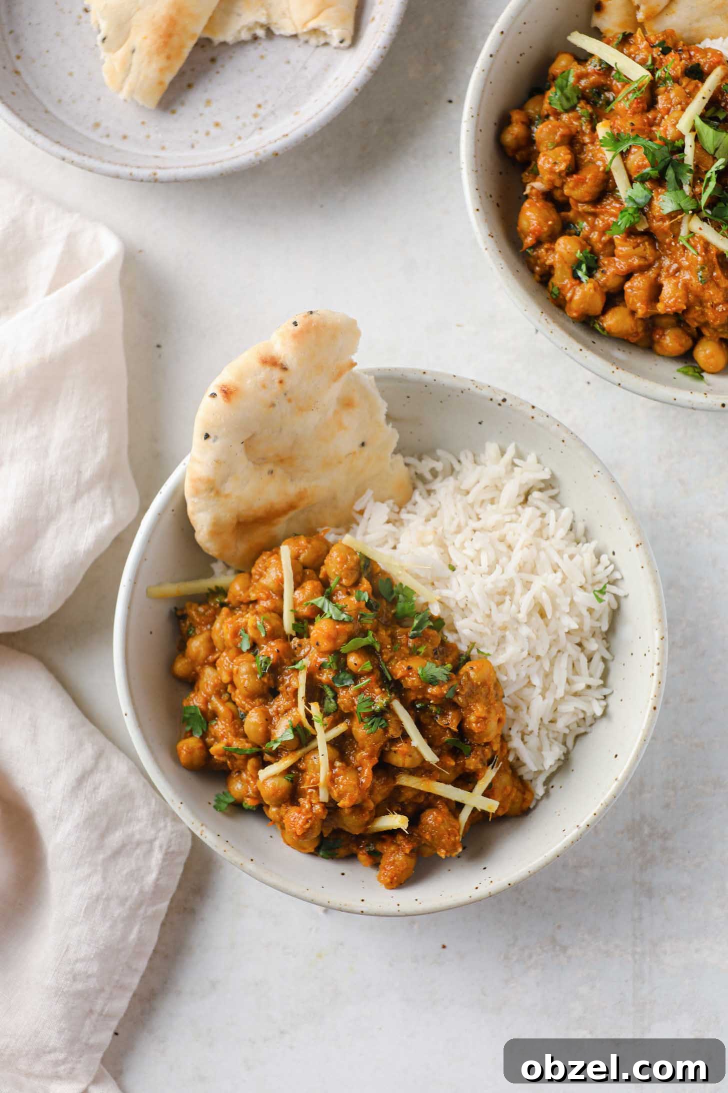 Indian Chickpea Curry in a bowl with rice and naan