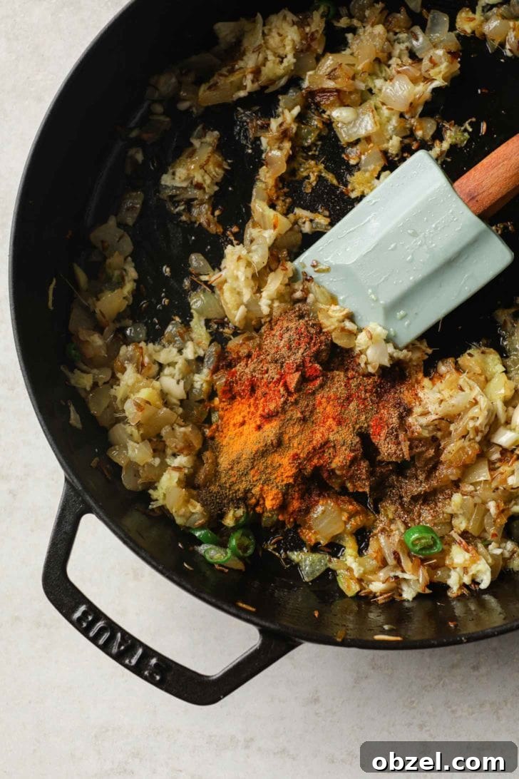 spices added to a base of browned onions in a skillet