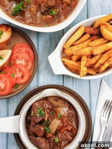 A dish of beef Trinchado alongside a bowl of french fries and garlic bread.