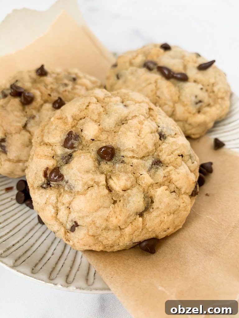a small plate with parchment paper and three cookies on it