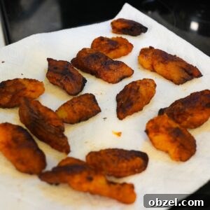 Crispy Fried Maduros (Sweet Plantains Recipe) 8 Fried sweet plantains on a paper towel.