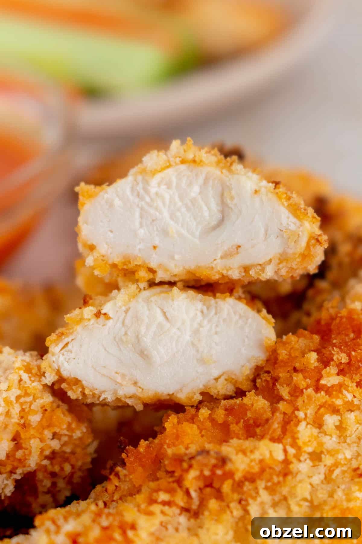 Crispy Air Fryer Buffalo Chicken Tenders 7 An air fryer buffalo chicken tender cut in half, showing the interior.