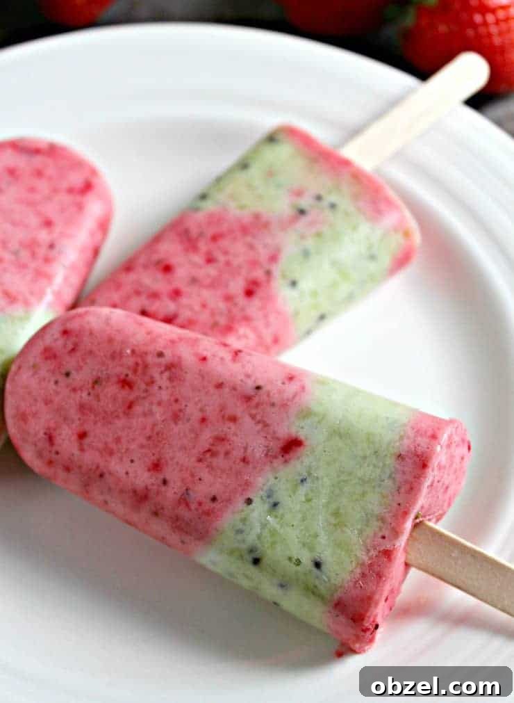 A plate with red and green frozen popsicles on the plate.