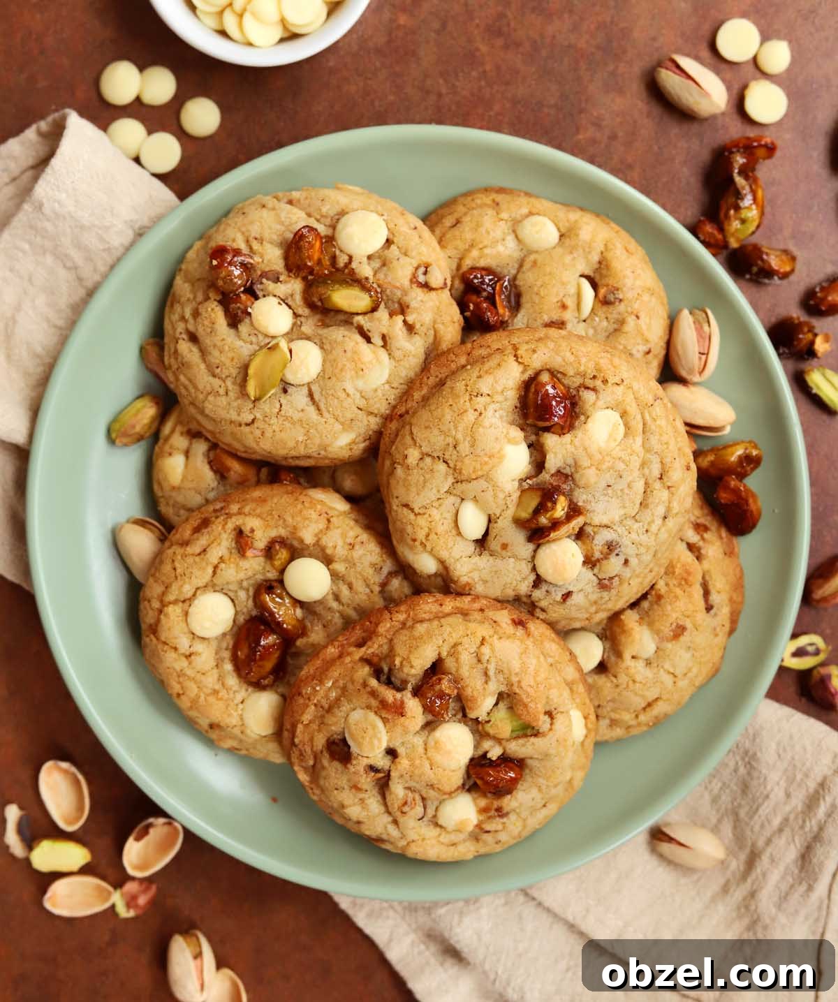 Brown Butter Pistachio White Chocolate Cookies 2 top view of caramelized pistachio brown butter white chocolate cookies on a plate