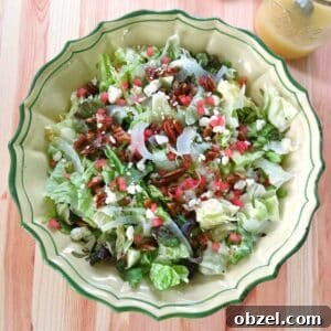 Summer fennel salad with shaved fennel, feta cheese, candied pecans, and watermelon in a large bowl.
