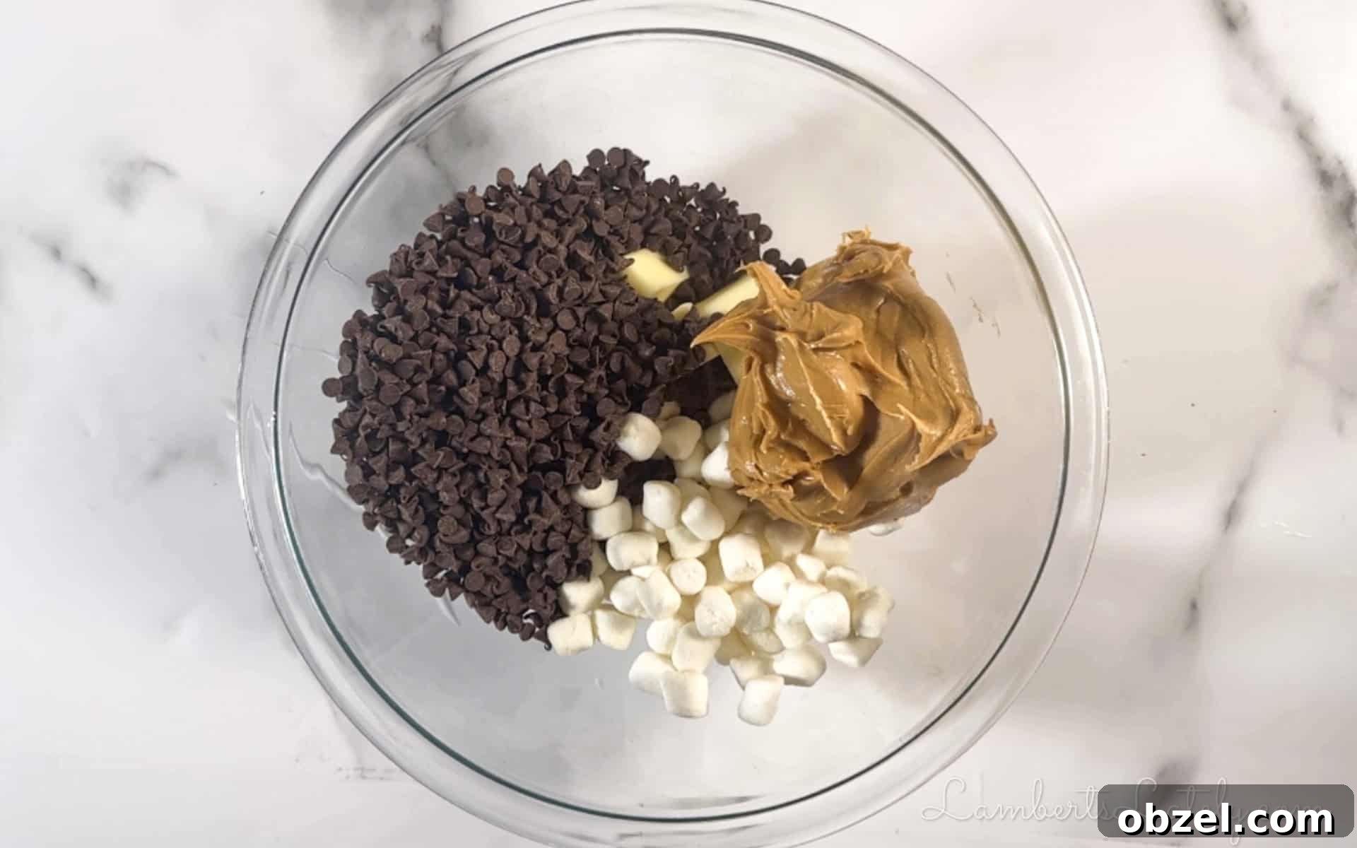 No Bake Muddy Buddy Cookies 4 peanut butter, chocolate chips, and marshmallows in a bowl.