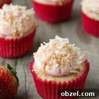 Strawberry, coconut and pineapple cupcakes topped with coconut frosting and toasted coconut
