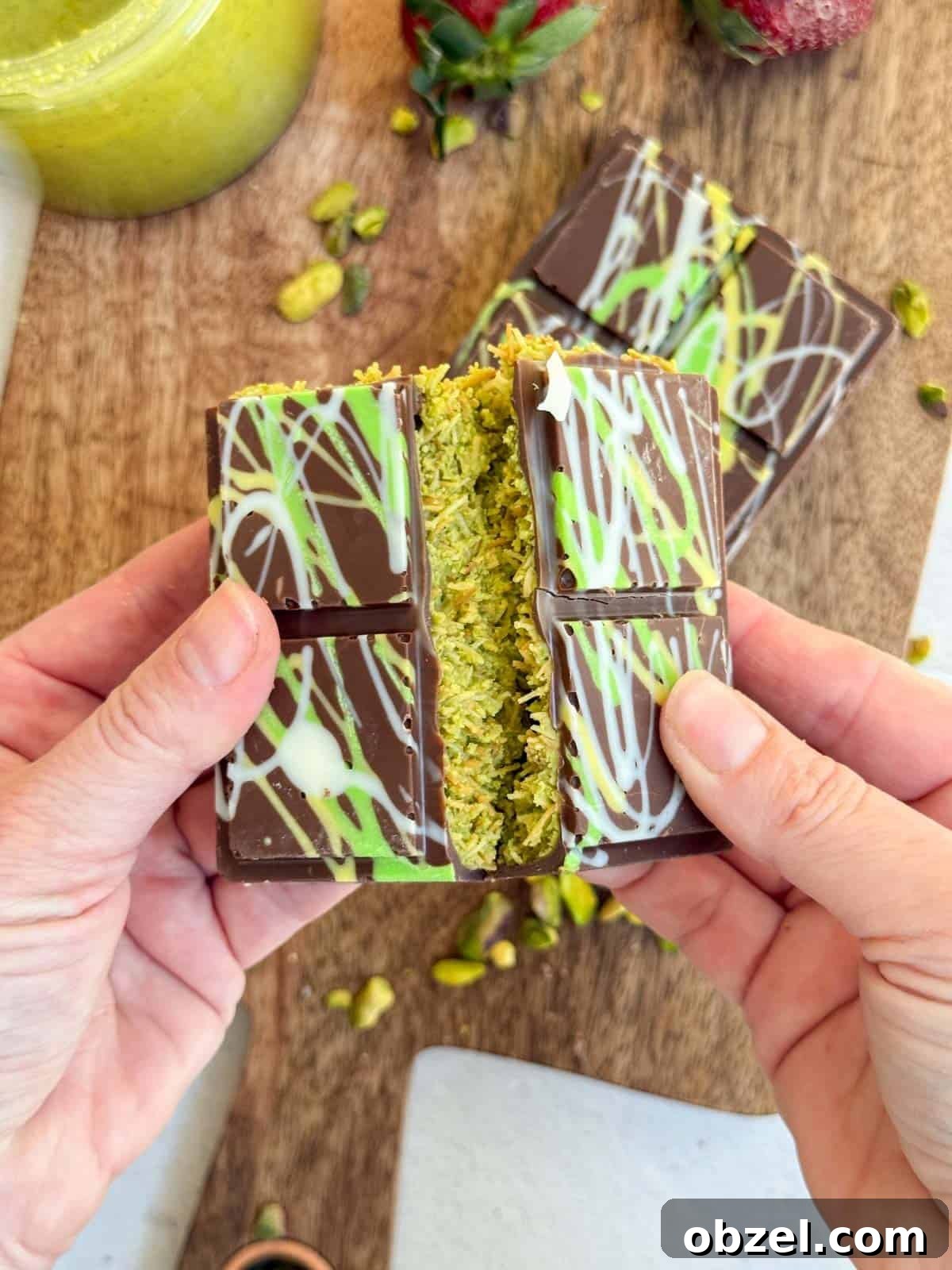 Dubai Chocolate Bar Recipe with Pistachio Knafeh Filling 12 Hands breaking the Dubai Chocolate Bar.