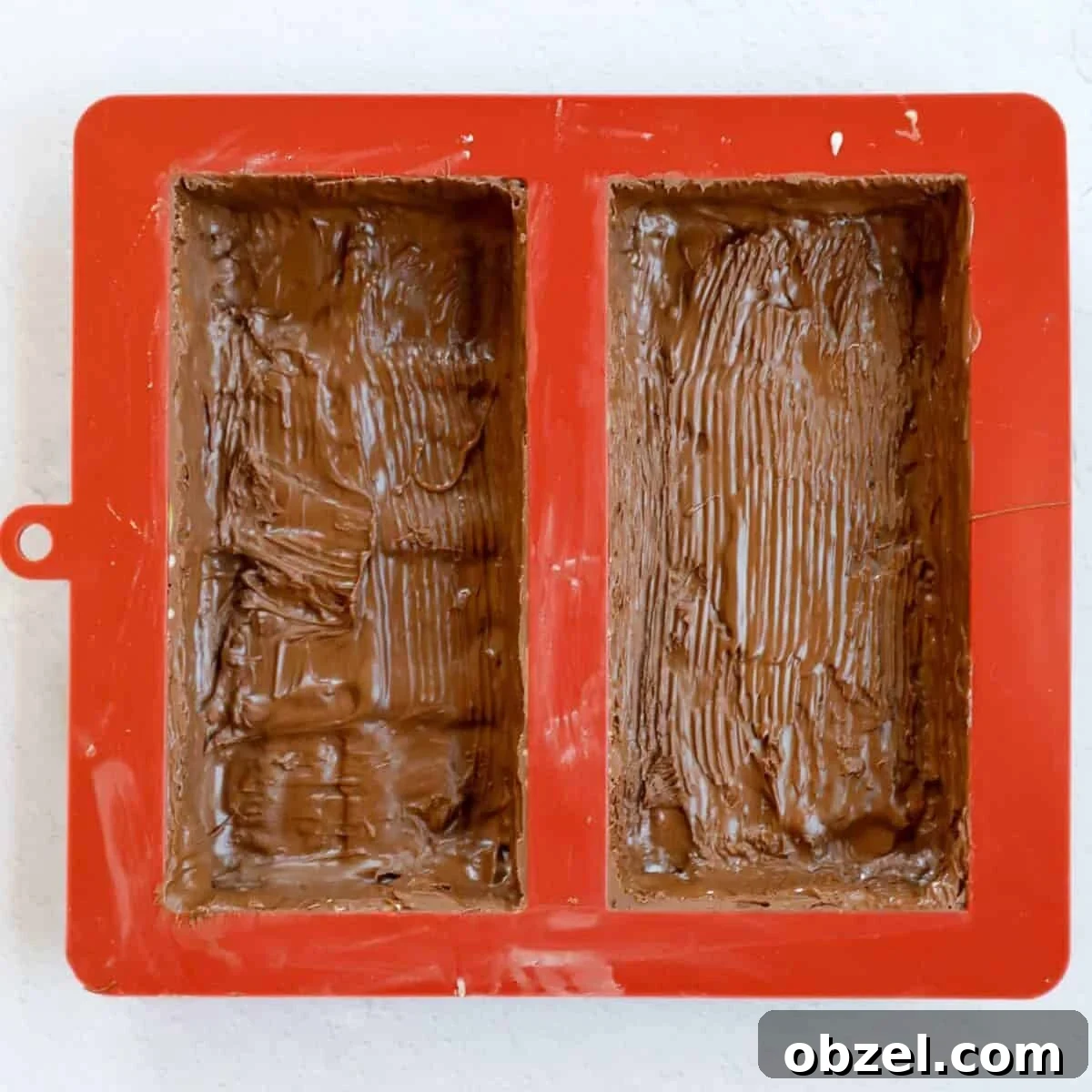 Dubai Chocolate Bar Recipe with Pistachio Knafeh Filling 8 Process of coating the chocolate mold with chocolate to make the outer shell.