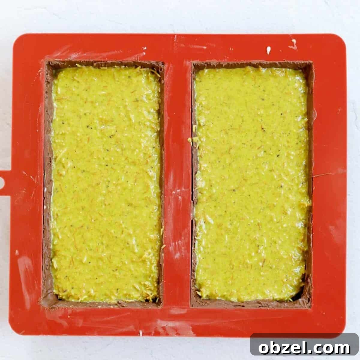 Dubai Chocolate Bar Recipe with Pistachio Knafeh Filling 9 Process shot showing addition of pistachio cream kunafa into the chocolate mold.