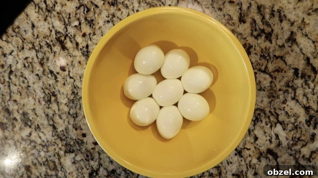Peeled eggs in a mixing bowl