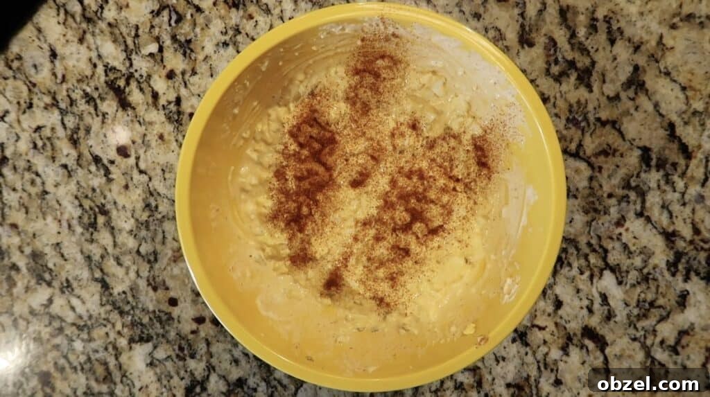 Adding more paprika to egg salad and letting rest on top