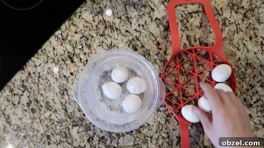 Placing pressure cooked hard-boiled eggs in ice bath