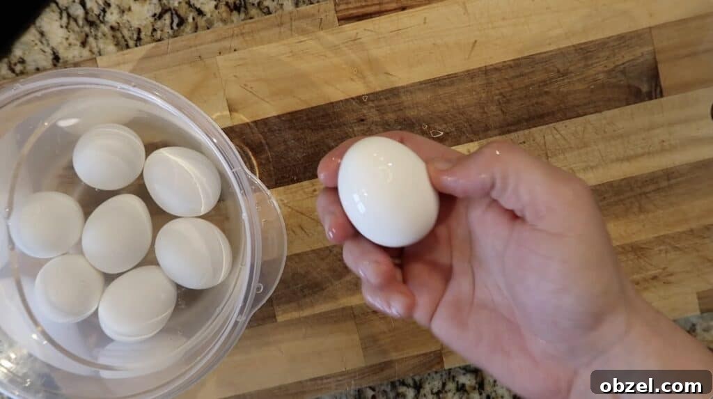 Taking a cooled egg from ice bath