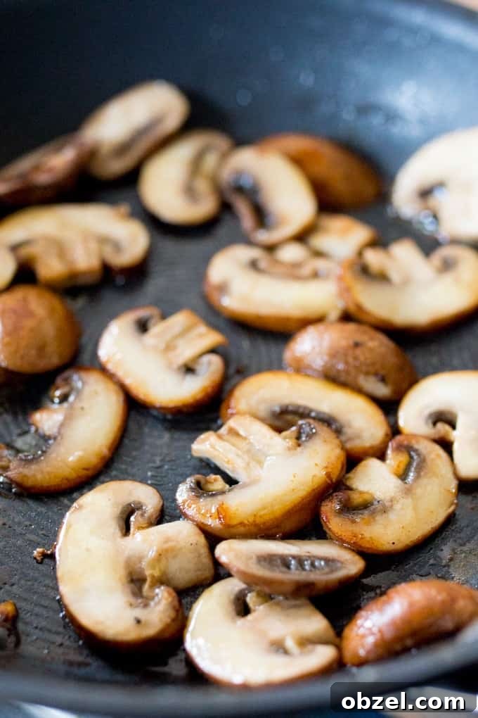 Garlic Mushroom and Brie Toast Recipe 3 mushrooms cooking in a pan