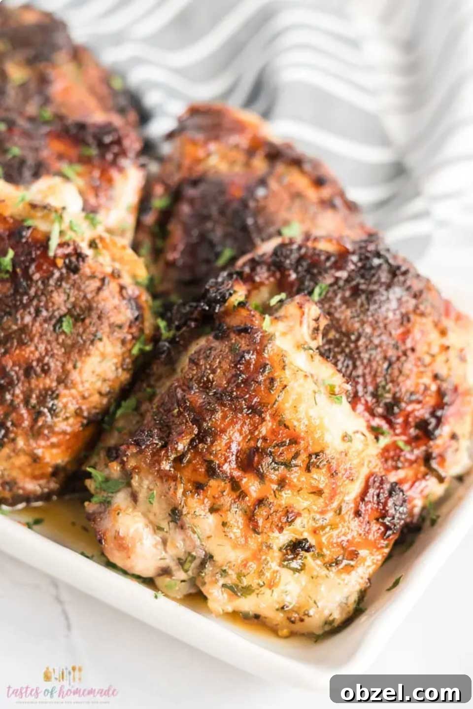 15 Air Fryer Chicken Thigh Recipes for Crispy, Juicy Results 11 Closeup of several thighs out of air fryer and on small white platter.