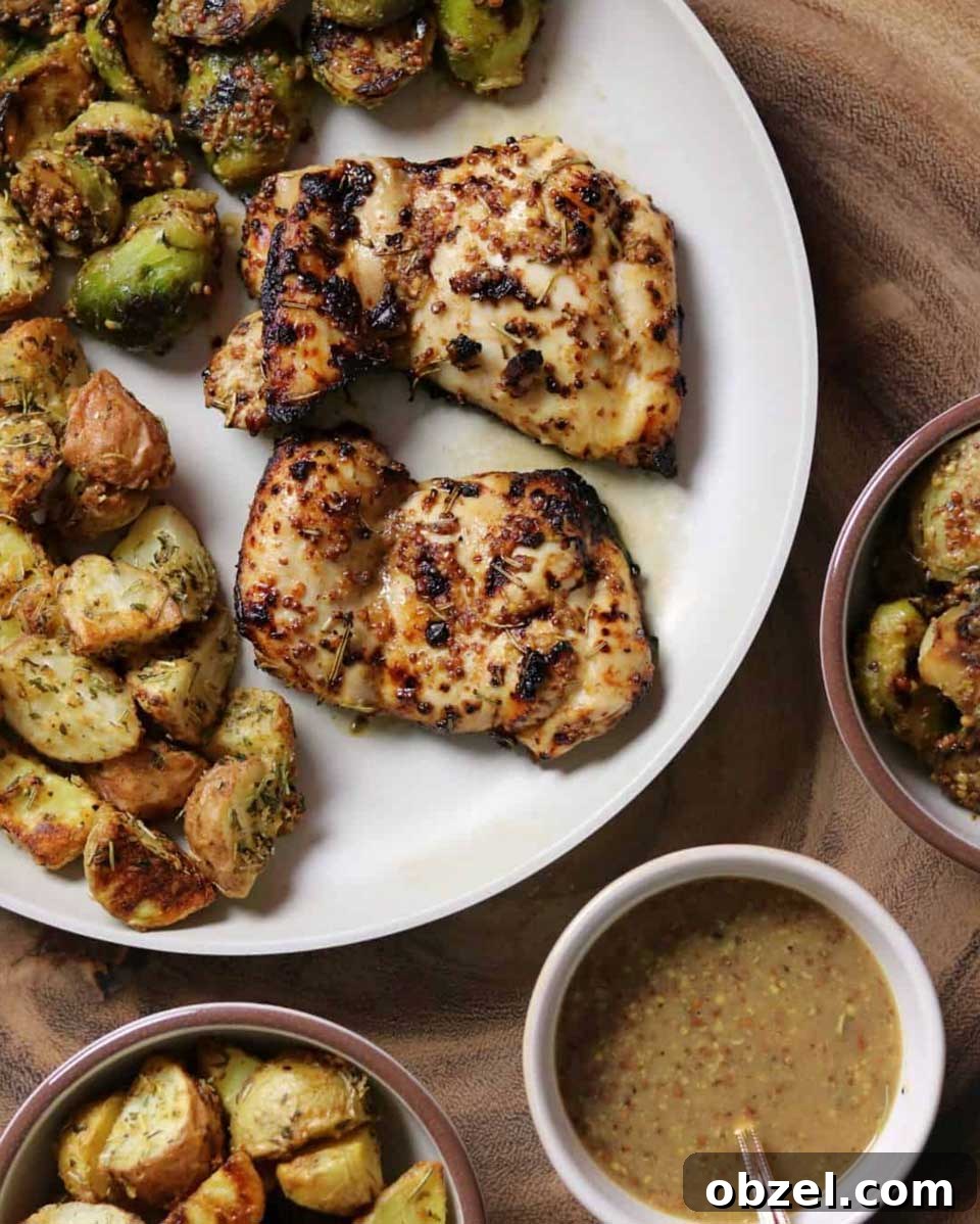 15 Air Fryer Chicken Thigh Recipes for Crispy, Juicy Results 15 Two Mustard Balsamic thighs after air frying, served on white plate with potatoes and Brussels sprouts.