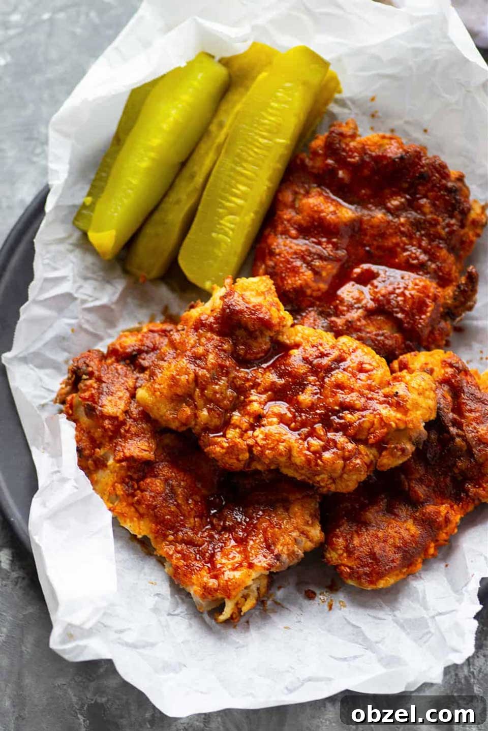15 Air Fryer Chicken Thigh Recipes for Crispy, Juicy Results 6 Several piece of air fryer chicken served on paper-lined plate with dill pickle spears.